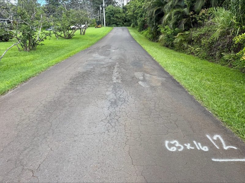 A surveyed problem area of road, measured and marked in paint on the pavement